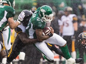 Anthony Allen #26 of the Saskatchewan Roughriders is tackled at the end of a run in heavy rain during week one of the 2014 CFL season at Mosaic Stadium on June 29, 2014 in Regina, Saskatchewan, Canada.  (Brent Just/Getty Images)