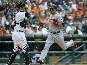 Cleveland's Lonnie Chisenhall, right, scores past Tigers catcher Bryan Holaday during the fifth inning of the first game of a doubleheader at Comerica Park on July 19, 2014 in Detroit, Michigan. (Duane Burleson/Getty Images)