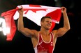 David Tremblay celebrates winning gold in the Men's 61kg wrestling at the Commonwealth Games in Glasgow. (Photo by Julian Finney/Getty Images)