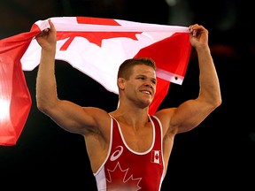 David Tremblay celebrates winning gold in the Men's 61kg wrestling at the Commonwealth Games in Glasgow. (Photo by Julian Finney/Getty Images)