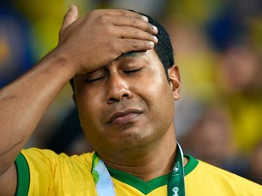 Fans of Brazil reacts after their team lost the semi-final football match between Brazil and Germany at The Mineirao Stadium in Belo Horizonte during the 2014 FIFA World Cup on July 8, 2014.  AFP PHOTO / FABRICE COFFRINIFABRICE COFFRINI/AFP/Getty Images