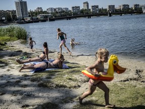 People enjoy near the Donbas river on July 24, 2014 in Donetsk. Fighting between Ukrainian troops and rebels raged today near the crash site of Malaysian flight MH17, as experts in Britain begin analysing crucial data from the downed airliner's black boxes. AFP PHOTO/ BULENT KILICBULENT KILIC/AFP/Getty Images