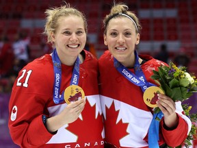 Ruthven's Meghan Agosta-Marciano, right, and Haley Irwin celebrate after defeating the United States 3-2 in overtime during the Sochi 2014 Winter Olympics. (Photo by Bruce Bennett/Getty Images)