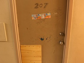 One of several damaged doors at the 920 Ouellette Ave. complex in Windsor, Ont. where many residents say they are disturbed by alleged criminal activities in the building.   (DAN JANISSE/The Windsor Star)