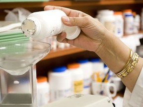 A pharmacist fills a prescription in a file photo. There is more good news about HIV treatment pills used to prevent infection in people at high risk of getting the AIDS virus: Follow-up from a landmark study that proved the drug works now shows that it does not encourage risky sex and is effective even if people skip some doses.
Photograph by: Aaron Lynett , National Post