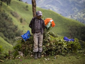 Gilberto Haroldo Ramos Juarez, 11, brother of Gilberto Francisco Ramos Juarez, a Guatemalan boy whose decomposed body was found in the Rio Grande Valley of South Texas, stands in front of his home in San Jose Las Flores, in the northern Cuchumatanes mountains of Guatemala, Tuesday, July 1, 2014.
