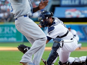Los Angeles Dodger Hanley Ramirez, left, runs past the tag of Detroit Tigers catcher Alex Avila to score in the first inning at Comerica Park Tuesday. (AP Photo/Paul Sancya)