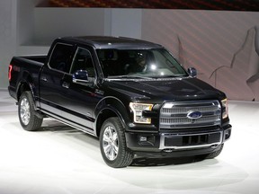 Ford unveils the new F-150 with a body built almost entirely out of aluminum. at the North American International Auto Show in Detroit. (AP Photo/Carlos Osorio)