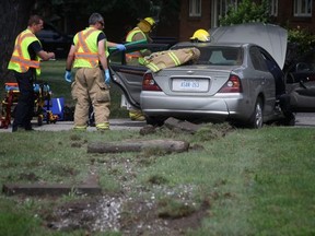 LaSalle Fire crews extricate a woman from her vehicle after a one-vehicle collision on Front Road Sunday morning.  (Dax Melmer/The Windsor Star)
