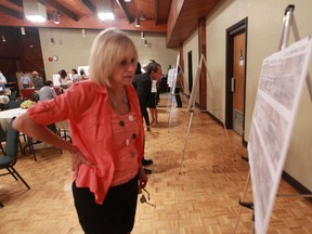 Cabana Road area resident Micheline Levesque looks at proposals during a public information session on a proposal for pedestrian and cycling paths along a 5.2-km stretch of Cabana Road  on July 24, 2014. (JASON KRYK/ Windsor Star)