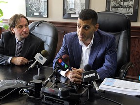 Thom Hunt and Mayor Eddie Francis take part in a press conference at city hall in Windsor on Thursday, July 10, 2014. The city is planning to make changes which will make it easier for builders and developers who are dealing with permits and planning.         (Tyler Brownbridge/The Windsor Star)