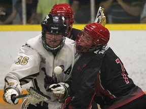 Windsor's Brendon Anger, left, and Wallaceburg's D.J. Nedelko battle for the ball during their playoff game Wednesday, July 2, 2014, at Forest Glade Arena in Windsor, Ont. (DAN JANISSE/The Windsor Star)