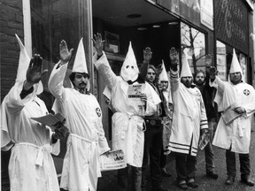 Ku Klux Klan members distribute pamplets in front of a store in the 100-block Hastings Street in Vancouver in February 1982. (Postmedia News files)