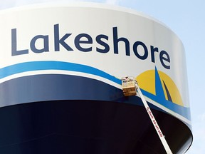 A worker paints the Lakeshore logo on a water tower   in Lakeshore on July 31, 2014. (JASON KRYK/The Windsor Star)