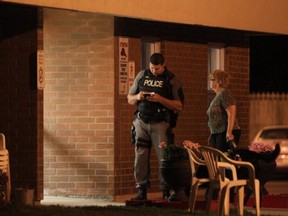 Police conducting interviews with residents of 140 Bridge, which is 14 storey high rise. A police officer on an ATV was injured in an accident on Riverside Drive West, near Bridge Avenue, around 6:15 p.m., Friday, July 18, 2014. (DAX MELMER/The Windsor Star)