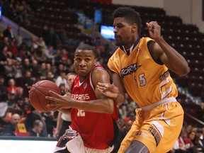 Windsor's Darren Duncan, left, cuts around Ed Jones from the Island Storm during Game 7 of the NBL of Canada championship final at the WFCU Centre.    (TYLER BROWNBRIDGE/The Windsor Star)