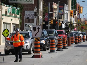 A construction worker stops traffic along Wyandotte Street East in this 2013 file photo. (DAX MELMER/The Windsor Star)