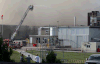 Workers watch as an aerial tower hoses down the fire at the Bonduelle plant on July 18, 2014. (Nick Brancaccio / The Windsor Star)