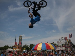 A member of the Craze Crew BMX stunt team performs a stunt in the air before the crowd at the Essex Fun Fest at the Essex Fair Grounds, Saturday, July 12, 2014.  (DAX MELMER/The Windsor Star)