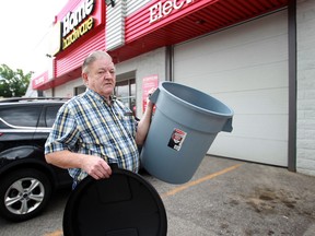 Customer Douglas Kelly displays a city approved garbage can he purchased as the Seminole Street Home Hardware  in Windsor, Ontario on July 16, 2014. (JASON KRYK/The Windsor Star)