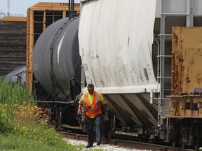 In this file photo, a CP Rail yard employee in Windsor is shown near freight and tanker cars on Monday, July 14, 2014. (DAN JANISSE/The Windsor Star)