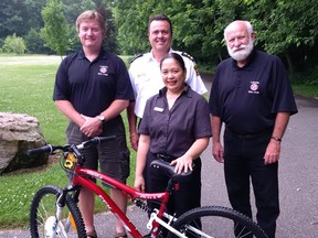 Chuck Stoffle, president of LaSalle Kin Club, from left, LaSalle Police Chief John Leontowicz, Jen Rocetes, manager of McDonalds Ojibway and  Ken Killen, vice-president of the LaSalle Kin Club show off the bicycle that one lucky child will win this summer in the LaSalle Police Service's 5th annual summer bicycle safety program.  LaSalle Police are looking for kids who demonstrate safe cycling skills and then entering them in the draw for the bike. Photo provided by LaSalle Police Service. (Courtesy of LaSalle Police Service)
