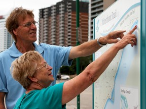 Alex McGill, top, and Nancy Jennings  point out a location along the waterfront trail, Wednesday, July 23, 2014. Jennings is visiting from the Falkland Islands and ended her visit with a walk by the Detroit River. (RICK DAWES/The Windsor Star)