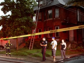 Windsor police and fire crews control the scene of a fire at 480 Vera Pl., near downtown, Sunday, July 27, 2014. Two families from the side by side dwelling have been taken in by Red Cross. (RICK DAWES/The Windsor Star)