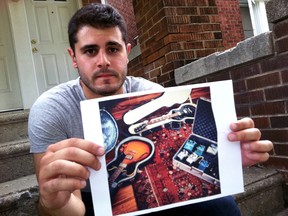 The Blue Stones musician Tarak Jafar holds up a picture of his guitars after they were stolen from his vehicle Tueday morning, parked in the alley behind his house on Gladstone Avenue. (JOEL BOYCE/The Windsor Star)