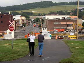 In this file photo, a couple looks at the downtown core Friday, July 4, 2014 in Lac-Megantic, Que. The one year anniversary of the train derailment and fire that left 47 people dead is observed July 6, 2014. THE CANADIAN PRESS/Ryan Remiorz
