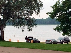 A scuba diver searches for a 44-year-old Hazel Park man, Tuesday, July 8, 2014, who reportedly failed to return from swimming at Stony Creek Metropark in Shelby Township, Mich., about 20 miles northeast of Detroit. (AP Photo/Detroit News,  Robert Allen)