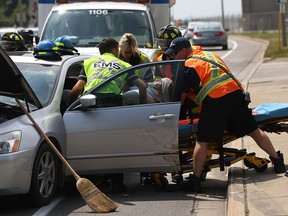Emergency crews extricate the driver of a Honda Accord after he was involved in a two-car motor vehicle accident with Honda CR-V at the intersection of Devonshire Rd. and Riverside Dr. East, Saturday, July 26, 2014.  (DAX MELMER/The Windsor Star)