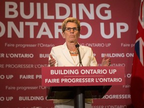 Ontario Premier Kathleen Wynne briefs the media following the Throne Speech at Queens Park in Toronto on Tuesday Thursday, July 3, 2014. THE CANADIAN PRESS/Chris Young