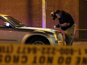 WINDSOR, ONT.: (6/19/14) -- A member of the Windsor police force investigates the scene of an accident on Pillette Road near Seminole Street, Saturday, July 19, 2014. Police said a woman, 64, was struck and suffered life-threatening injuries. She died Sunday morning. (RICK DAWES/The Windsor Star)