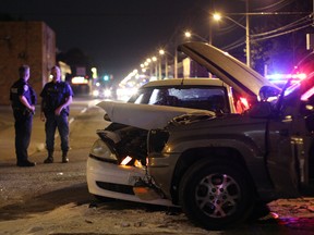 Windsor police officers investigate a two vehicle collision at the intersection of Seminole Street and Labadie Road Saturday night, July 26, 2014. One person was sent to hospital with minor injuries. (RICK DAWES/The Windsor Star)