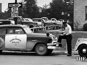 A policeman's lot indeed is not a happy one. Either he's giving out a parking ticket or he's getting one. Star Staff Photographer Jack Dalgleish snapped this city police constable on the morning of Aug. 15, 1955 ticketing the cruiser of a provincial police constable parked on City Hall Square. The ticketed policeman was in the police office --maybe testifying on another ticketing. The metered time was expired but justice goes on. (JACK DALGLEISH/The Windsor Star)