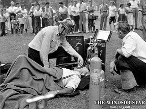 One victim receives medical attention at the Jackson Park Grandstand Band Shell fire in this July 12, 1957 file photo. (FILES/The Windsor Star)