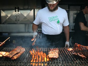 'Orange' cooks up racks of ribs on the BBQ for Ribs Royale at the 5th annual Amherstburg Rotary Ribfest at Centennial Park, Sunday, July 6, 2014.  (DAX MELMER/The Windsor Star)