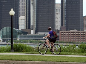 A cyclist takes advantage of mild weather to ride on Windsor's riverfront on July 3, 2014. (Tyler Brownbridge / The Windsor Star)