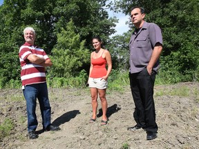 Doug Horton, left, Moria Tonge and Dave Landry, all longtime residents on Salina Ave. in Windsor, Ont. are shown in a field near the dead end of their street. They are upset that a new housing project may open the road to heavy traffic. (DAN JANISSE/The Windsor Star)