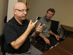David Kerr, left, and Aurele Bourgois speak through interpreter Christie Reaume (not seen) at the CHS offices in Windsor on Wednesday, July 2, 2014. There is a shortage of qualified interpreters in the city.        (Tyler Brownbridge/The Windsor Star)