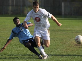 York Region's Daryl Gomez, left, battles Windsor's Chris Suta at Windsor Stadium, Sunday, Oct. 14, 2012. Suta and the Stars dropped their first game of the season in Ontario League One. (DAX MELMER/The Windsor Star)