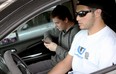 Teenage motorist Antonio Cianpa, 18, right, and his passenger Brett Primeau, 17, left, pull out from the 7-11 parking lot at the corner of Tecumseh Road East and McDougall Avenue, Wednesday, July 9, 2014. Both said they believe texting and driving is a common occurrence on the roads. (RICK DAWES/The Windsor Star)