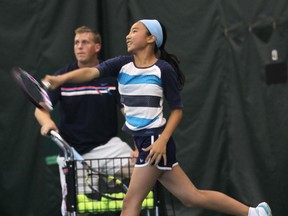Jeannie Vhang, 11, works with tennis coach James Schroeder at the Parkside Tennis Club in Windsor, Ont. on Thursday, July 3, 2014. He was reacting to the recent success of professional Canadian tennis players. (DAN JANISSE/The Windsor Star)