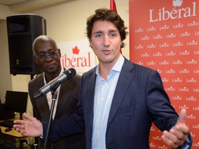 Liberal Leader Justin Trudeau attends the opening of a Liberal riding office in Montreal, Tuesday, Sept.10, 2013 with candidate Emmanuel Dubourg. THE CANADIAN PRESS/Ryan Remiorz