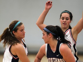 Holy Names' Nicole Tamm, left, and Carly Steer tie up Massey's Josephine Mastronardi, centre, in first half playoff basketball action. (NICK BRANCACCIO/The Windsor Star)