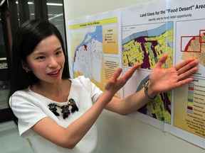 Carina Xue Luo, geospatial data analyst at University of Windsor points out 'food deserts' in some areas of Windsor August 6, 2014. Map shows heavy industrial and resource land use in 'food desert' area around Windsor train station. (NICK BRANCACCIO/The Windsor Star)