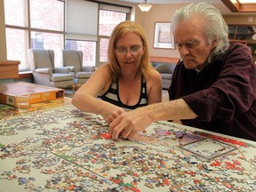 Schlegel Village at St. Clair neighbour Alex Morrison works on a puzzle with daughter-in-law Dawn Morrison August 7, 2014. (NICK BRANCACCIO/The Windsor Star)