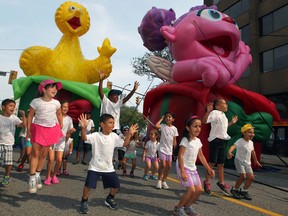 Day care students with Delta Chi jump for joy during a Balloonapalooza news conference announcing festival highlights on Ouellette Avenue August 8, 2014. (NICK BRANCACCIO/The Windsor Star)