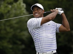 Tiger Woods winces after tee shot on the sixth hole during the second round of the PGA Championship golf tournament at Valhalla Golf Club on Friday, Aug. 8, 2014, in Louisville, Ky. (AP Photo/Jeff Roberson)